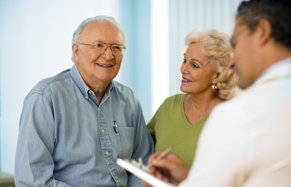 Smiling couple talking to provider