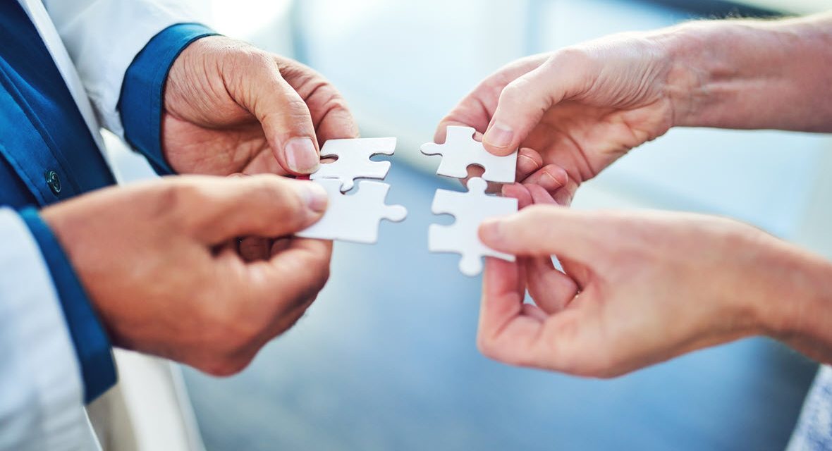 Two providers holding puzzle pieces